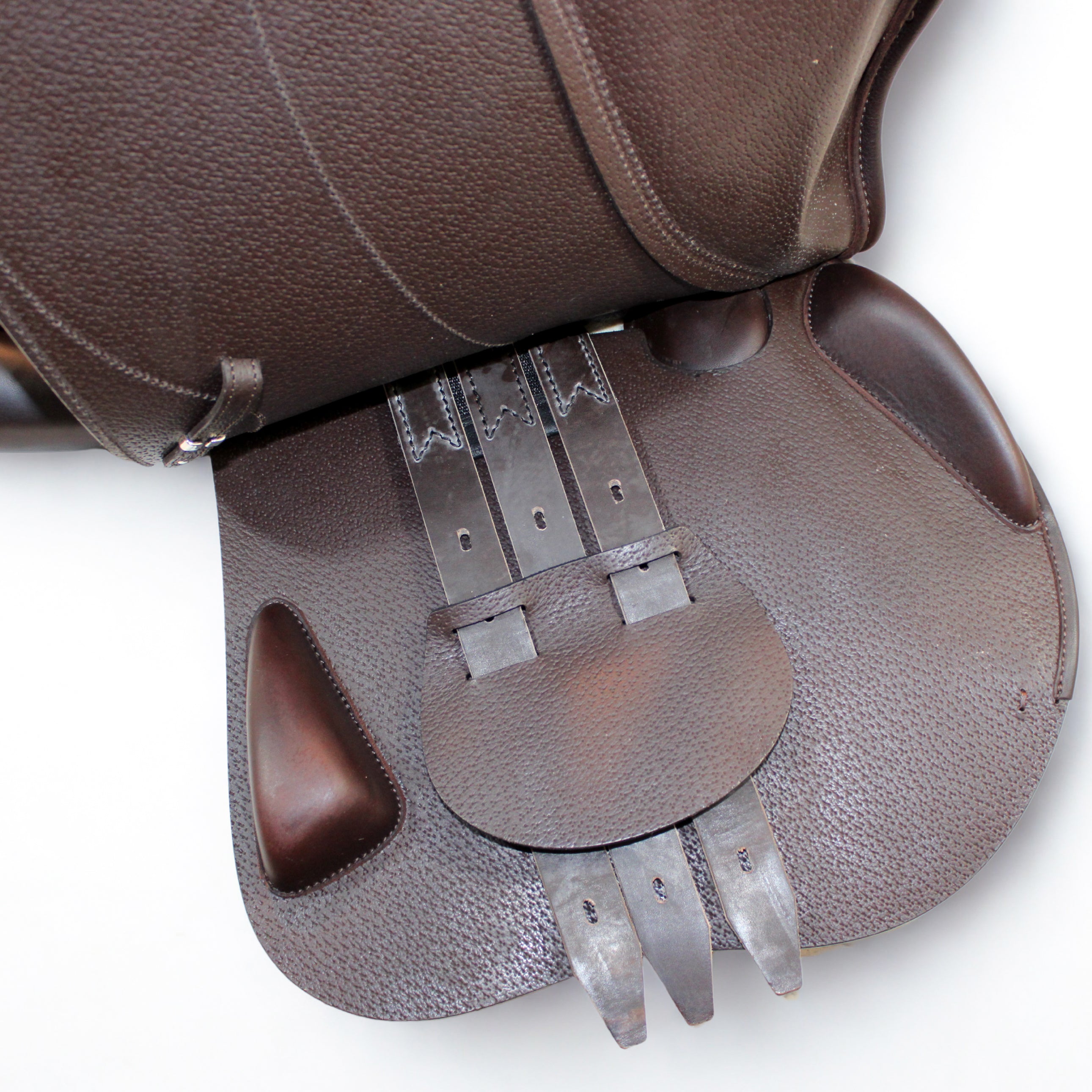 Right side profile view of an Equipe Grand Prix dual flap jump saddle with the main flap lifted to see the billets, front blocks, and back blocks. The underside of the main flap and the sweat flap have a grain texture.