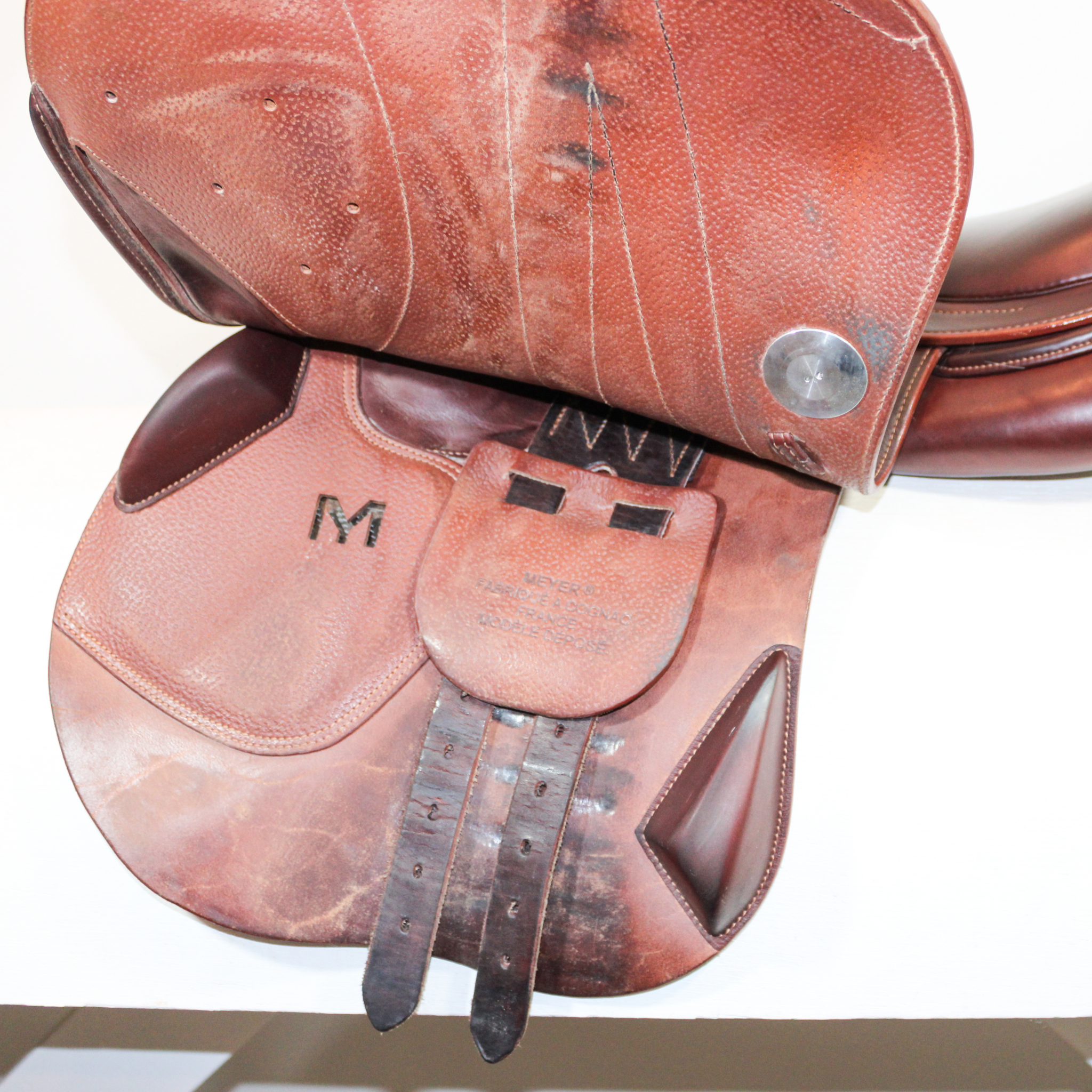 Left side profile view of a Meyer Act 2 jump saddle with the main flap lifted to see the billets, front blocks, and back blocks.