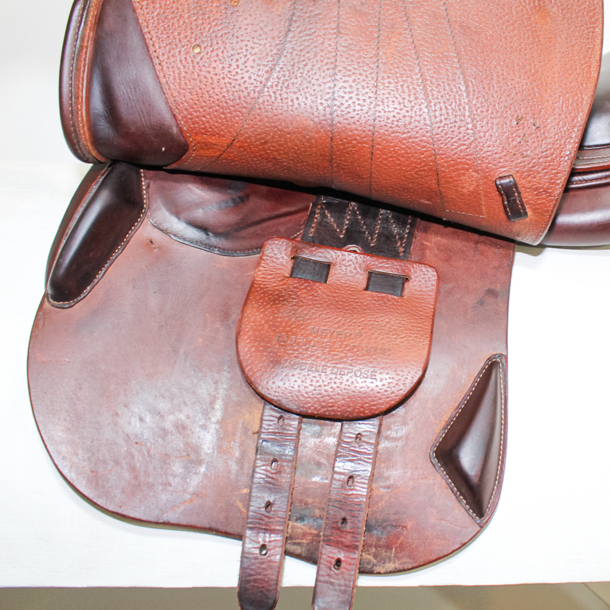 Left side profile view of Meyer Kids Act 1 dual flap jump saddle with the main flap lifted to see the billets, front blocks, and back blocks.