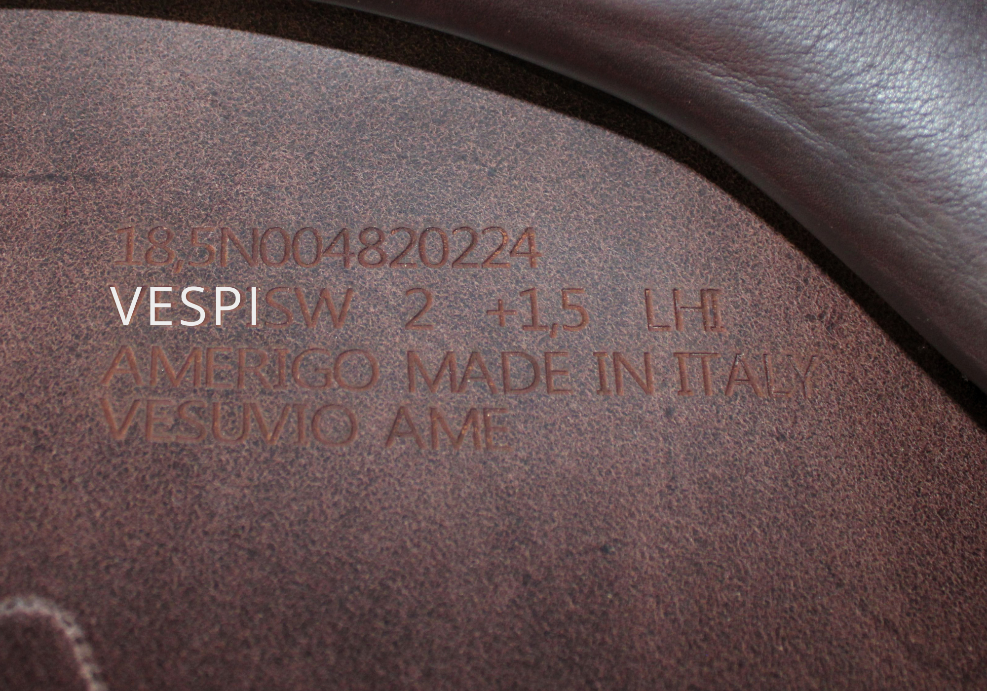 Close up of an Amerigo stamp with "VESPI" highlighted in white text.