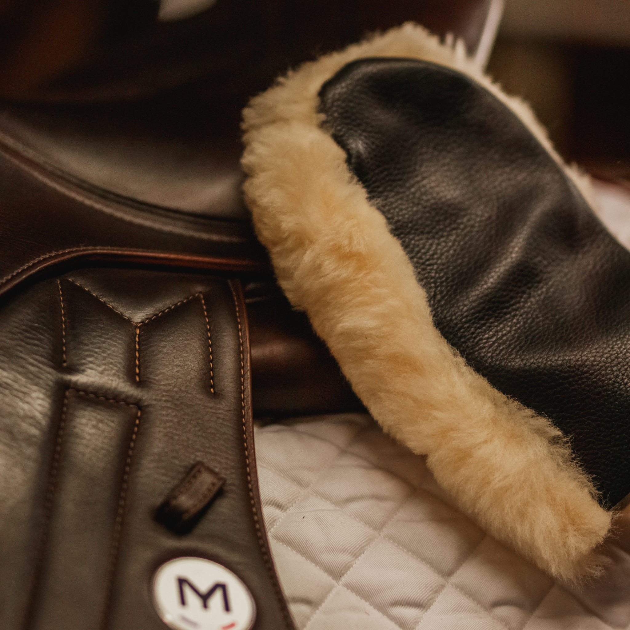 Sheepskin mitt being used to clean a Meyer saddle.