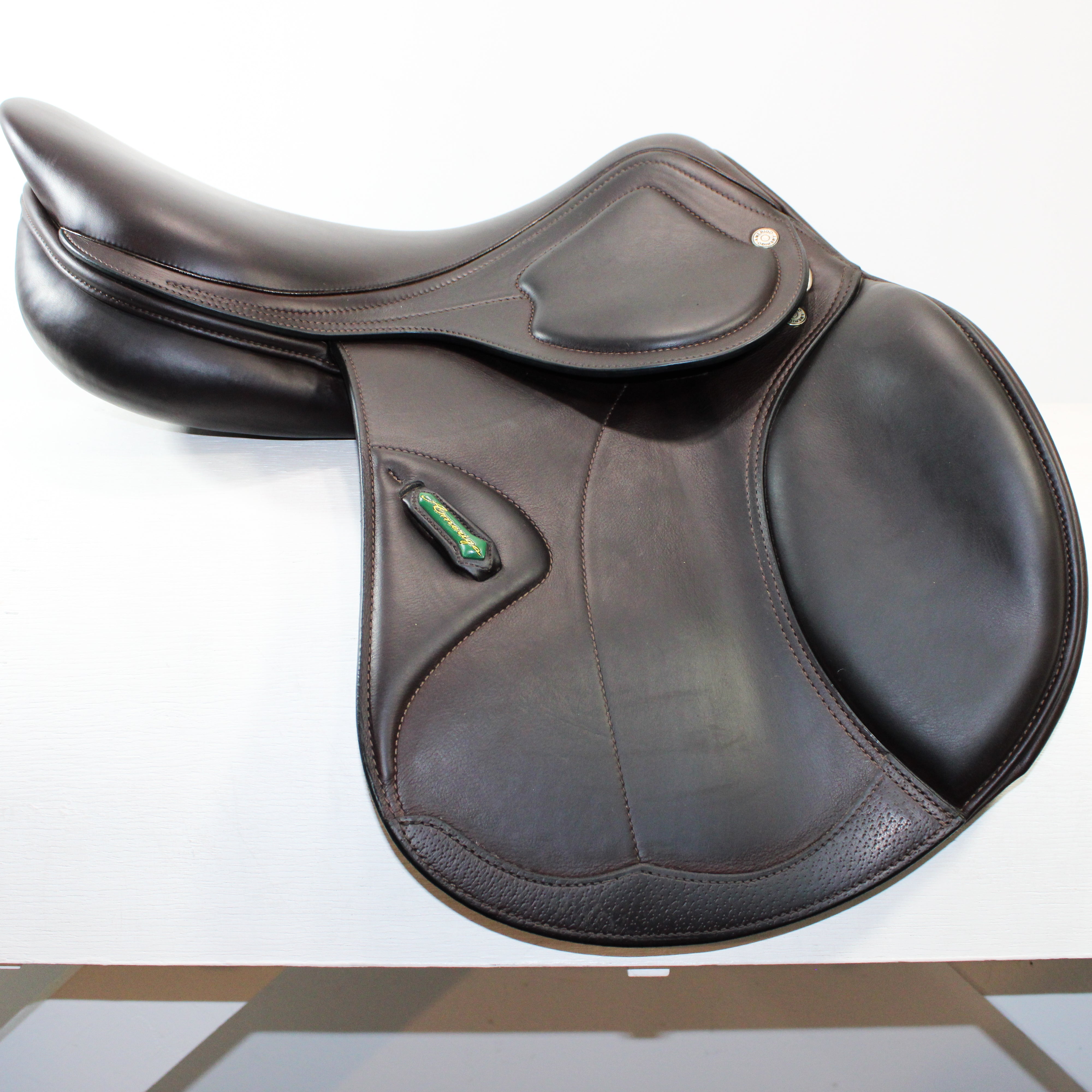 Right side profile view of an Amerigo DJ saddle in dark brown calf leather, with a green and yellow Amerigo logo loop