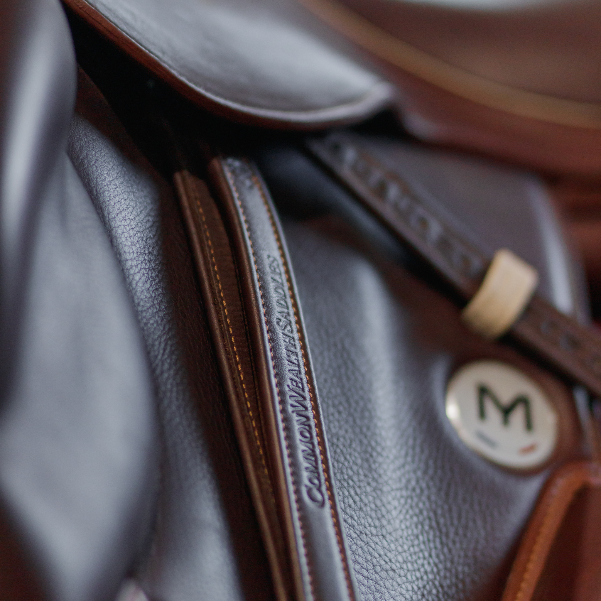 Brown Yoho rolled stirrup leathers hanging from a brown monoflap saddle.