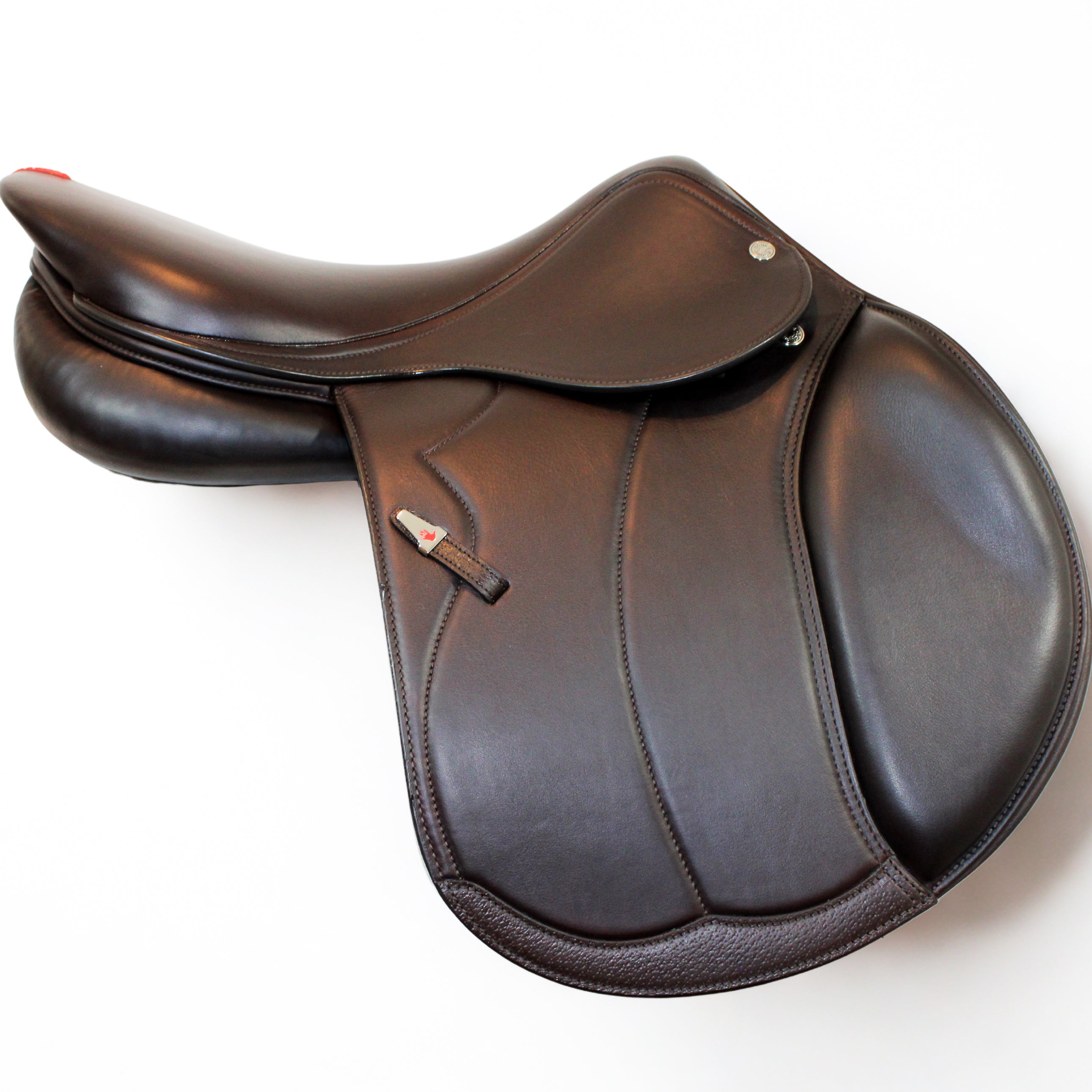 Left side profile view of an Equipe Grand Prix dual flap jump saddle in brown calf leather