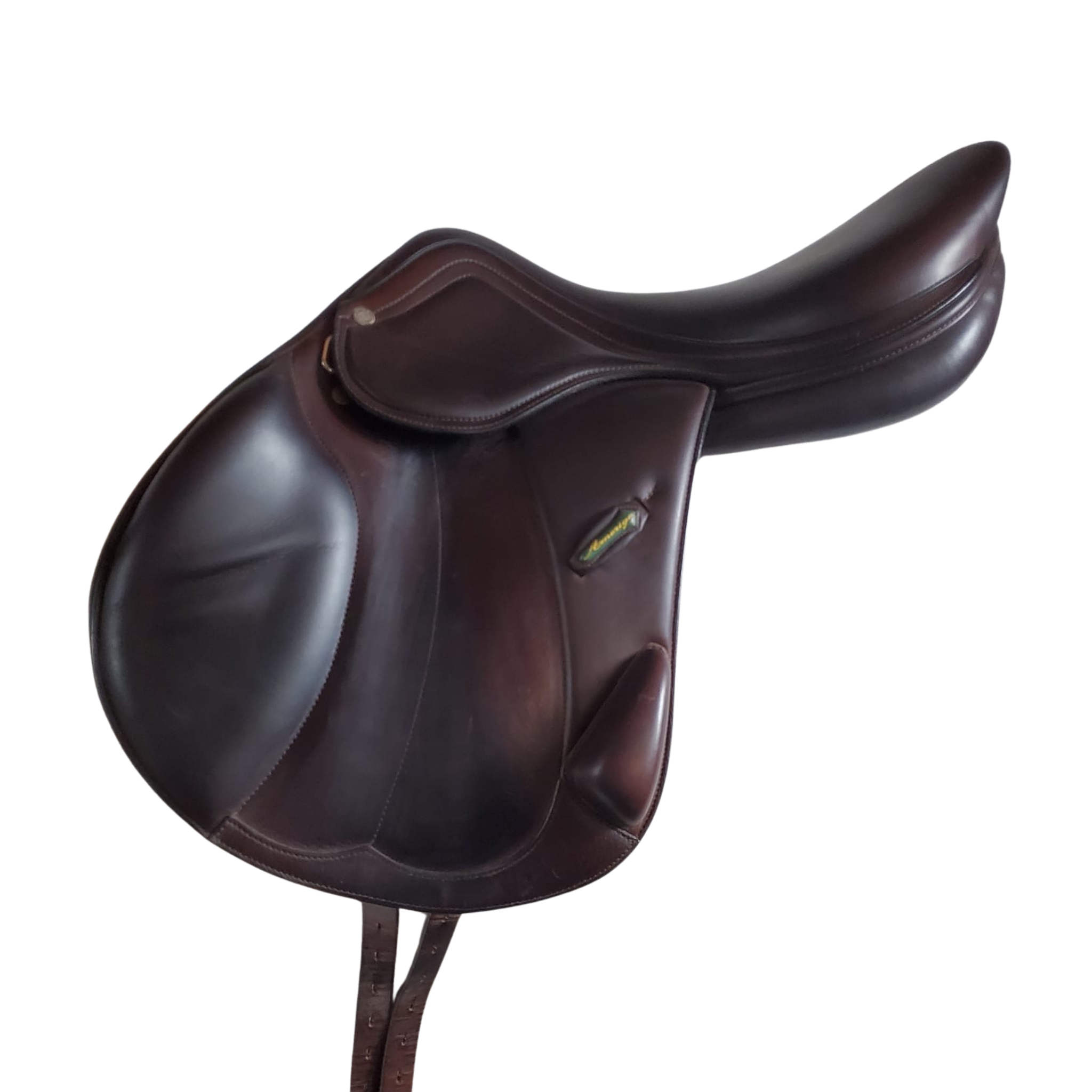 Left side profile view of an Amerigo Vega monoflap jump saddle in brown calf leather, with a green and yellow Amerigo logo loop.