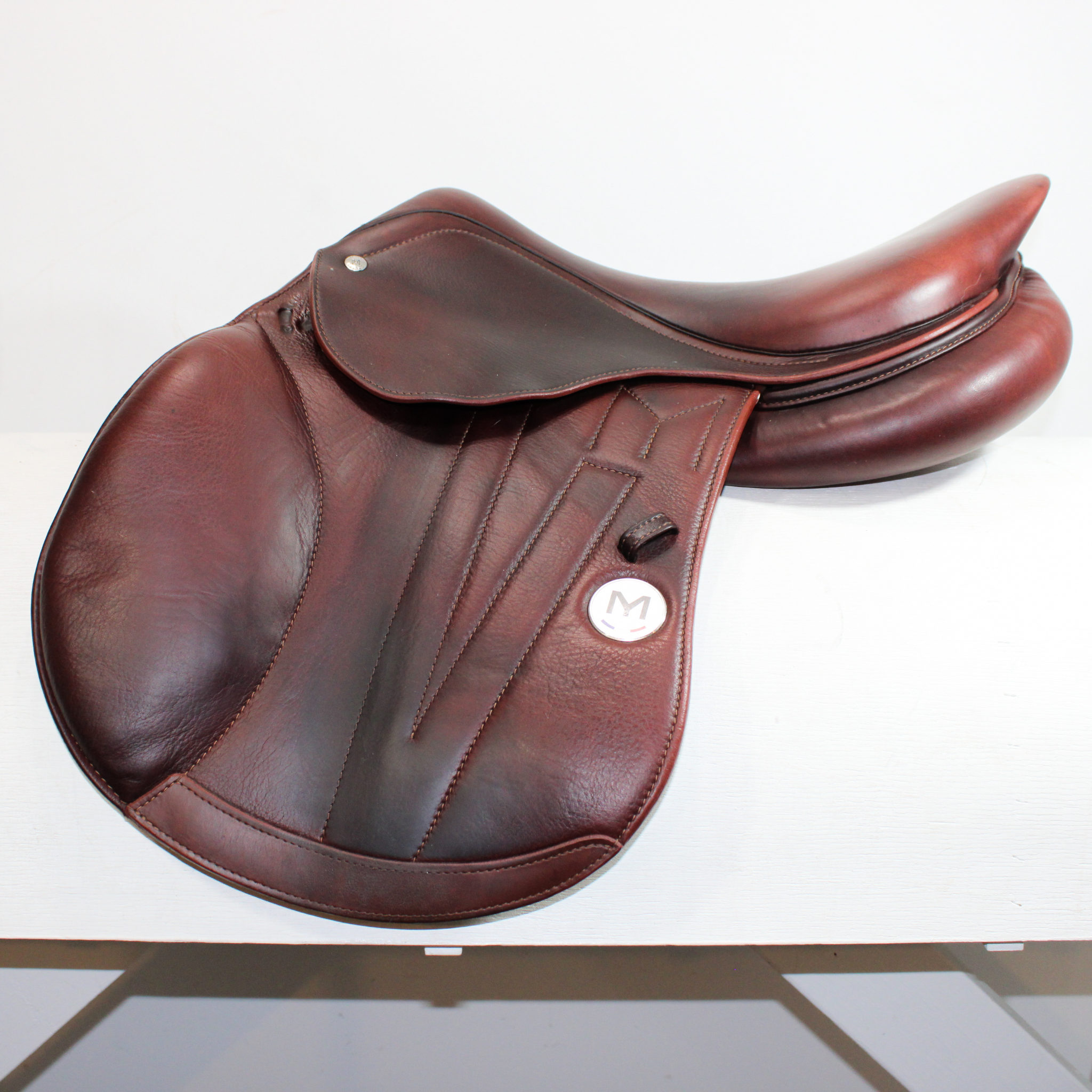 Left side profile view of a Meyer Act 2 jump saddle in brown calf leather, with a white Meyer logo. 