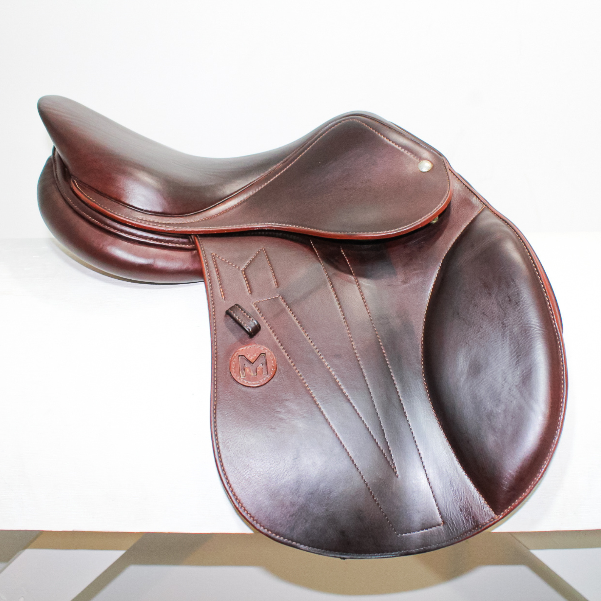 Right side profile view of a Meyer Kids Act 1 dual flap jump saddle in brown calf leather, with a leather Meyer logo on the flap