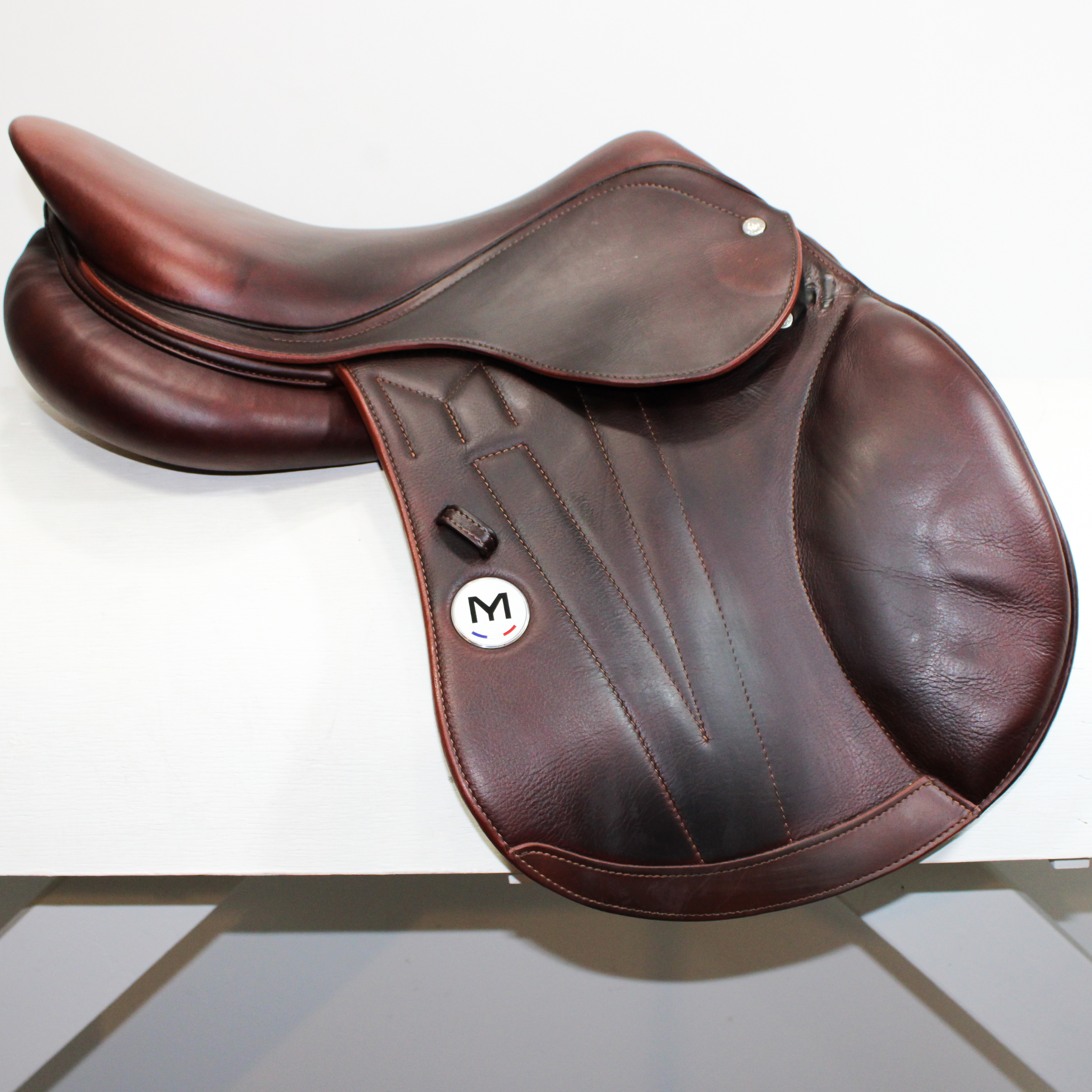 Right side profile view of a Meyer Act 2 jump saddle in brown calf leather, with a white Meyer logo. 