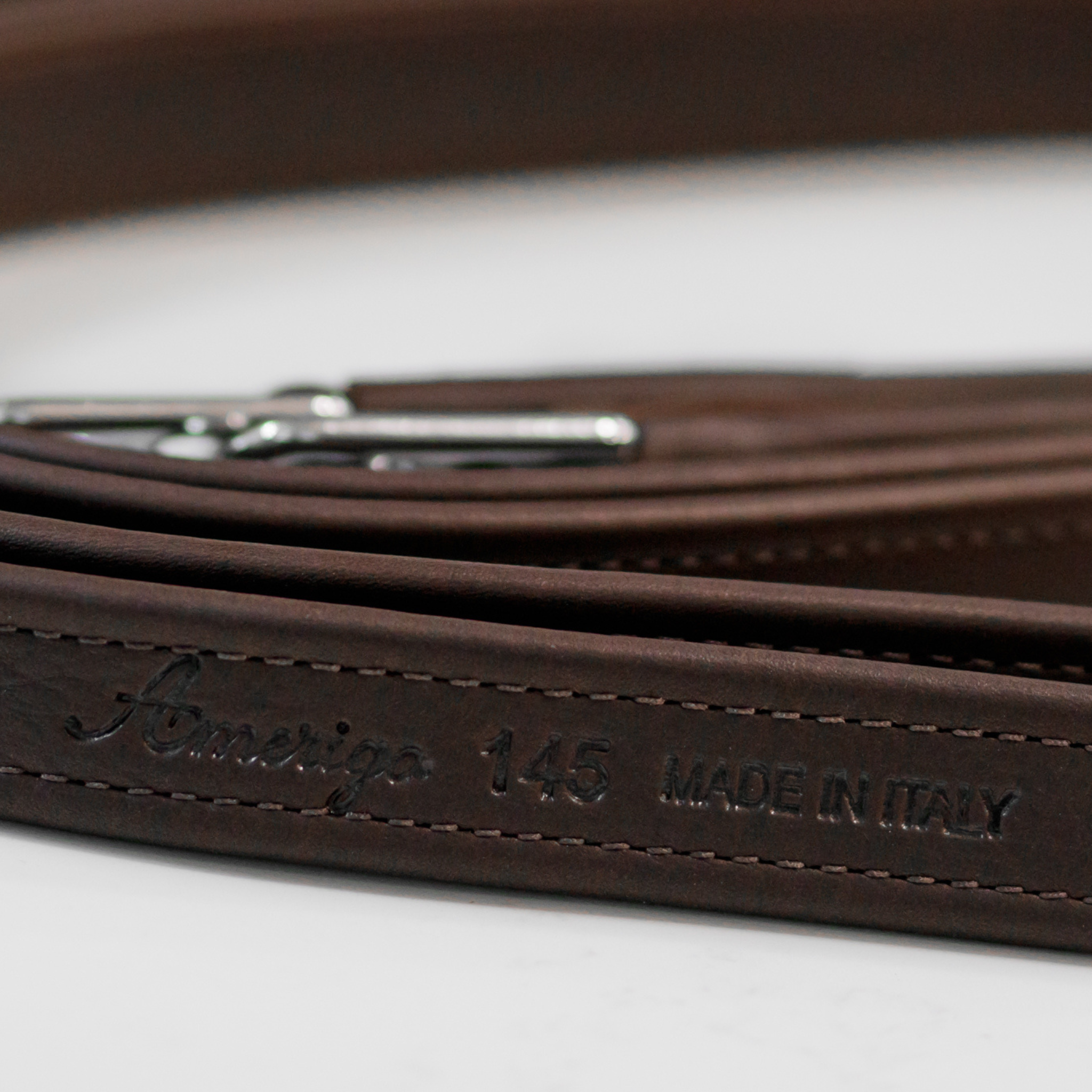 Close up photo of Amerigo logo, leather size (145 cm) and 'Made in Italy' stamp on tail end of an Amerigo stirrup leather