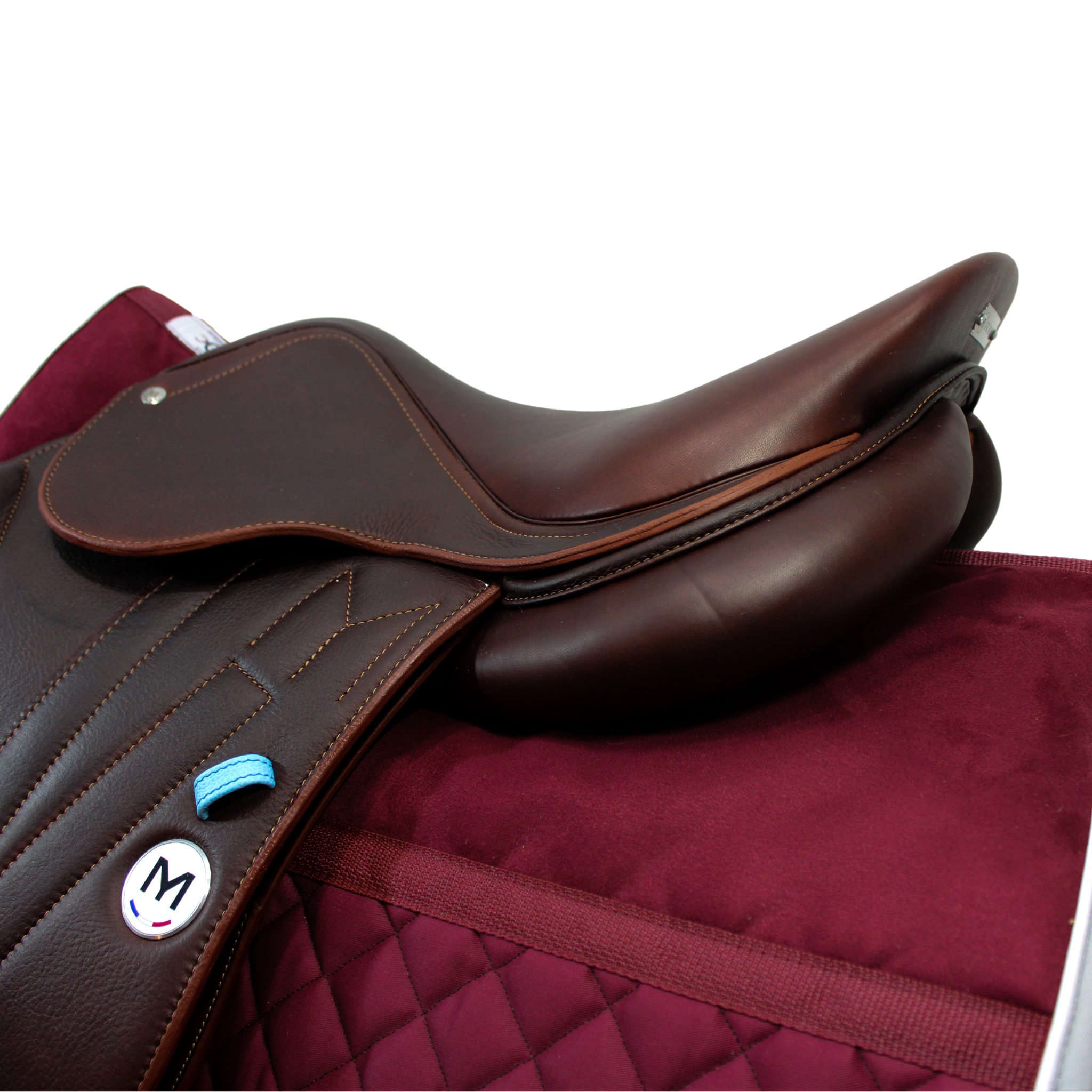 A burgundy friction-free Ogilvy saddle pad underneath a Meyer saddle