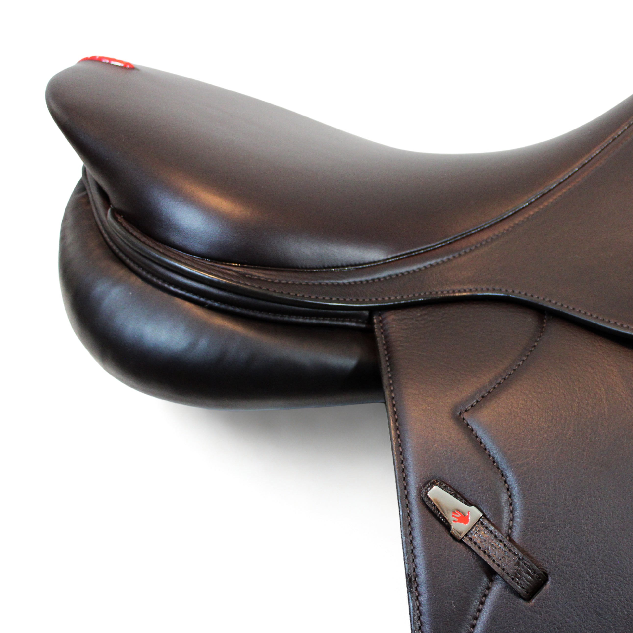 Close up right side profile view of an Equipe Grand Prix dual flap jump saddle in brown calf leather with a focus on the cantle and rear panel area