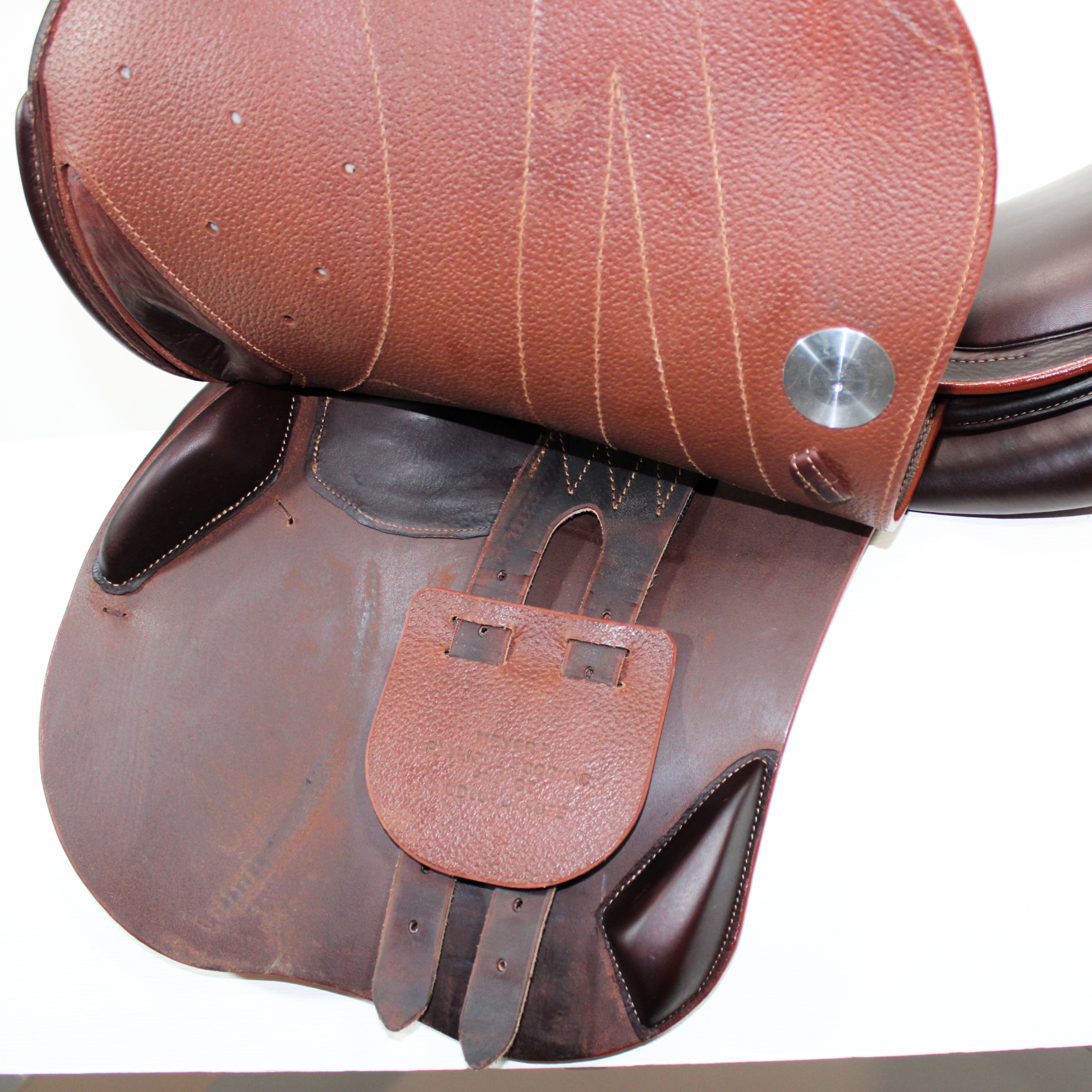 Left side profile view of a Meyer Act 1 jump saddle with the main flap lifted to see the billets, front blocks, and back blocks. 