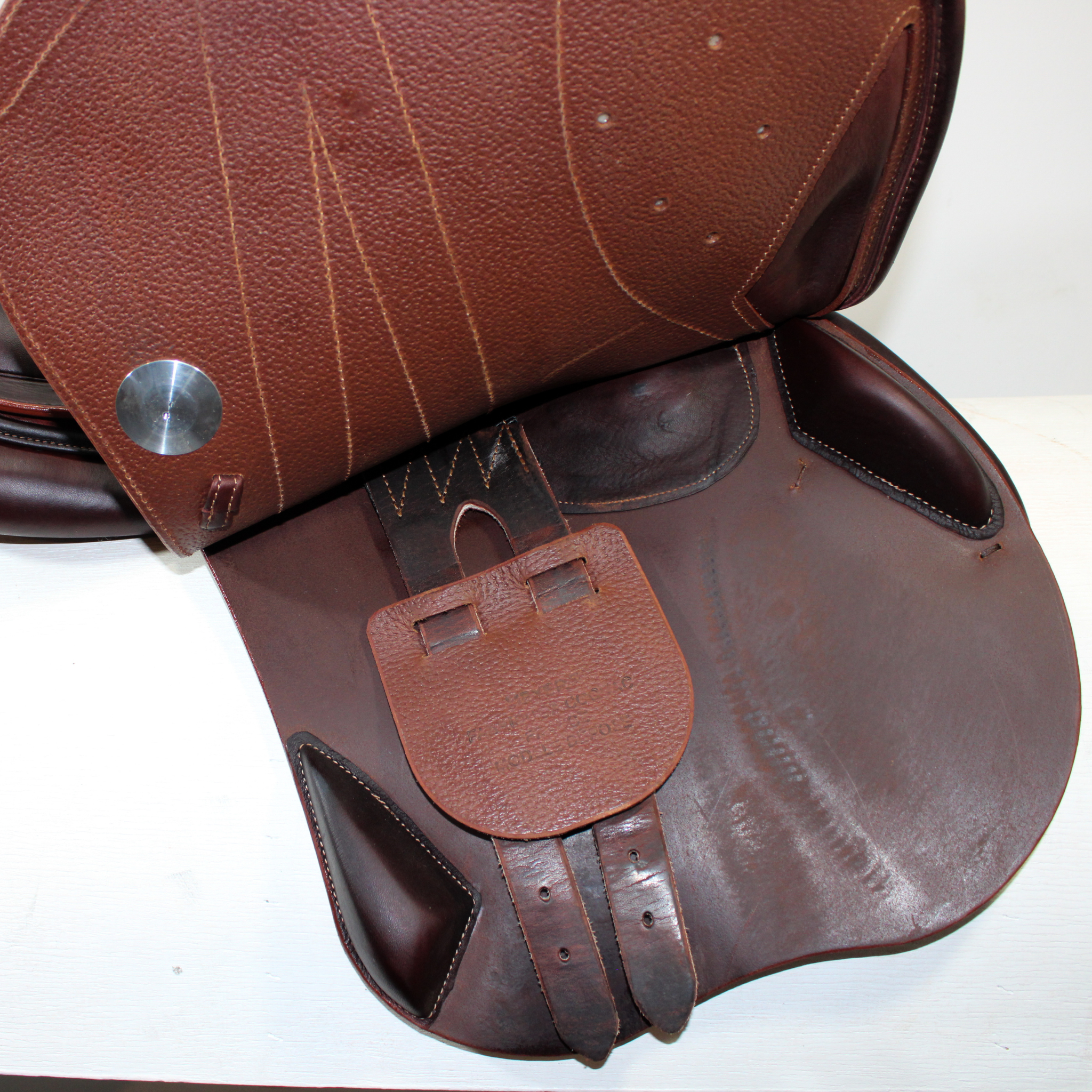 Right side profile view of a Meyer Act 1 jump saddle with the main flap lifted to see the billets, front blocks, and back blocks. 