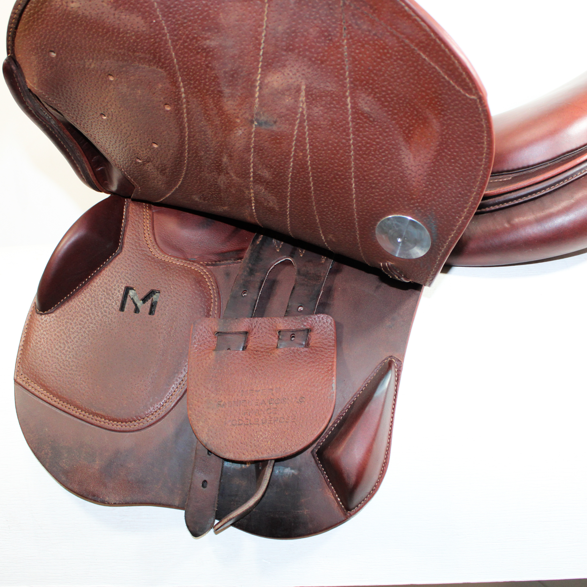 Left side profile view of a Meyer Act 2 jump saddle with the main flap lifted to see the billets, front blocks, and back blocks. 