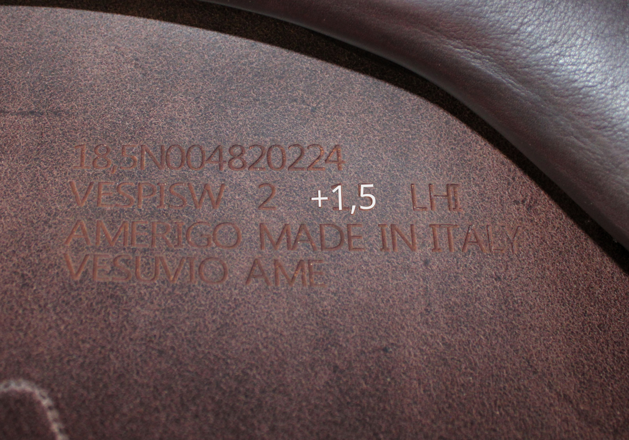 Close up of an Amerigo stamp with "+1,5" highlighted in white text.