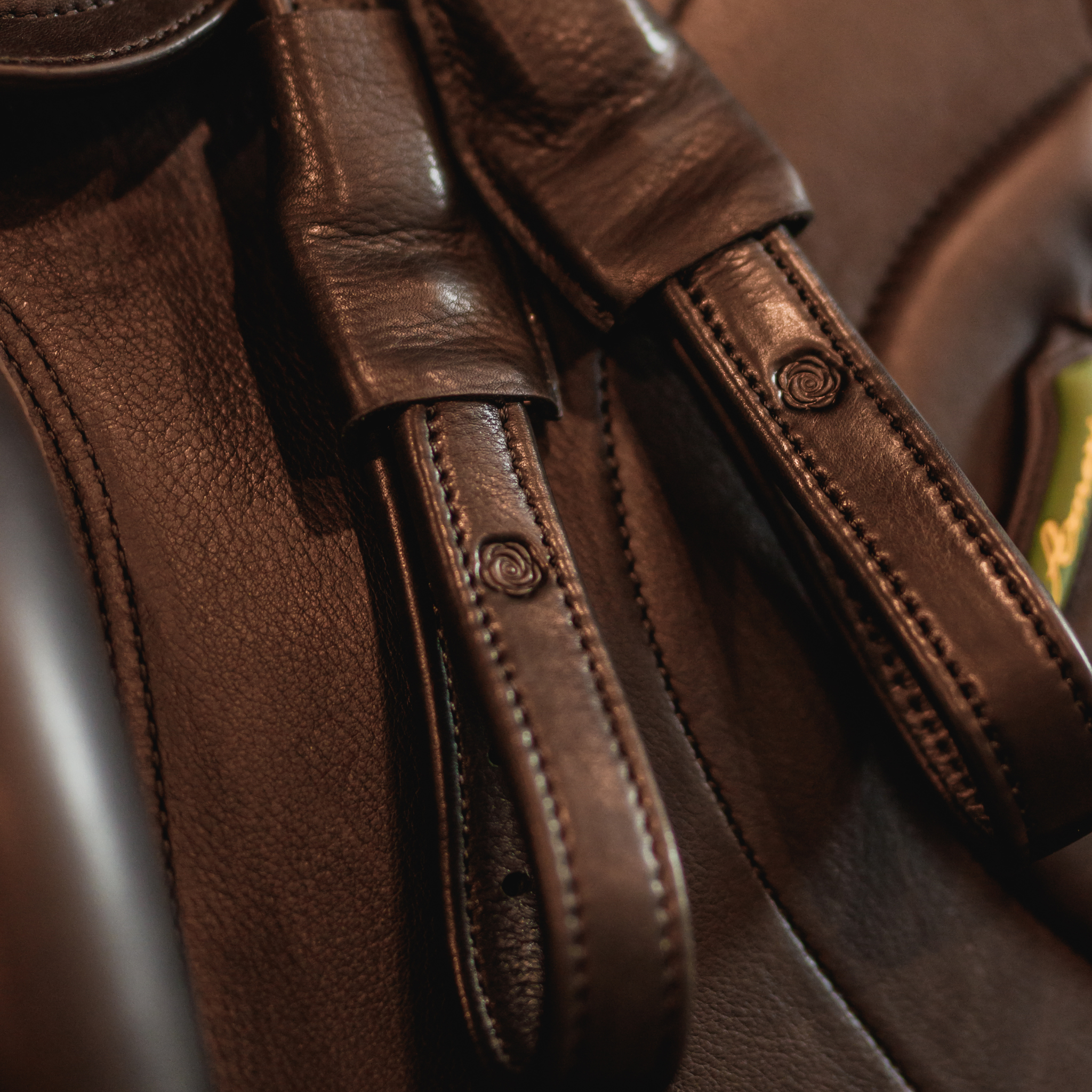 Black Brome Mono Leathers sitting on top of a black Amerigo dressage saddle.