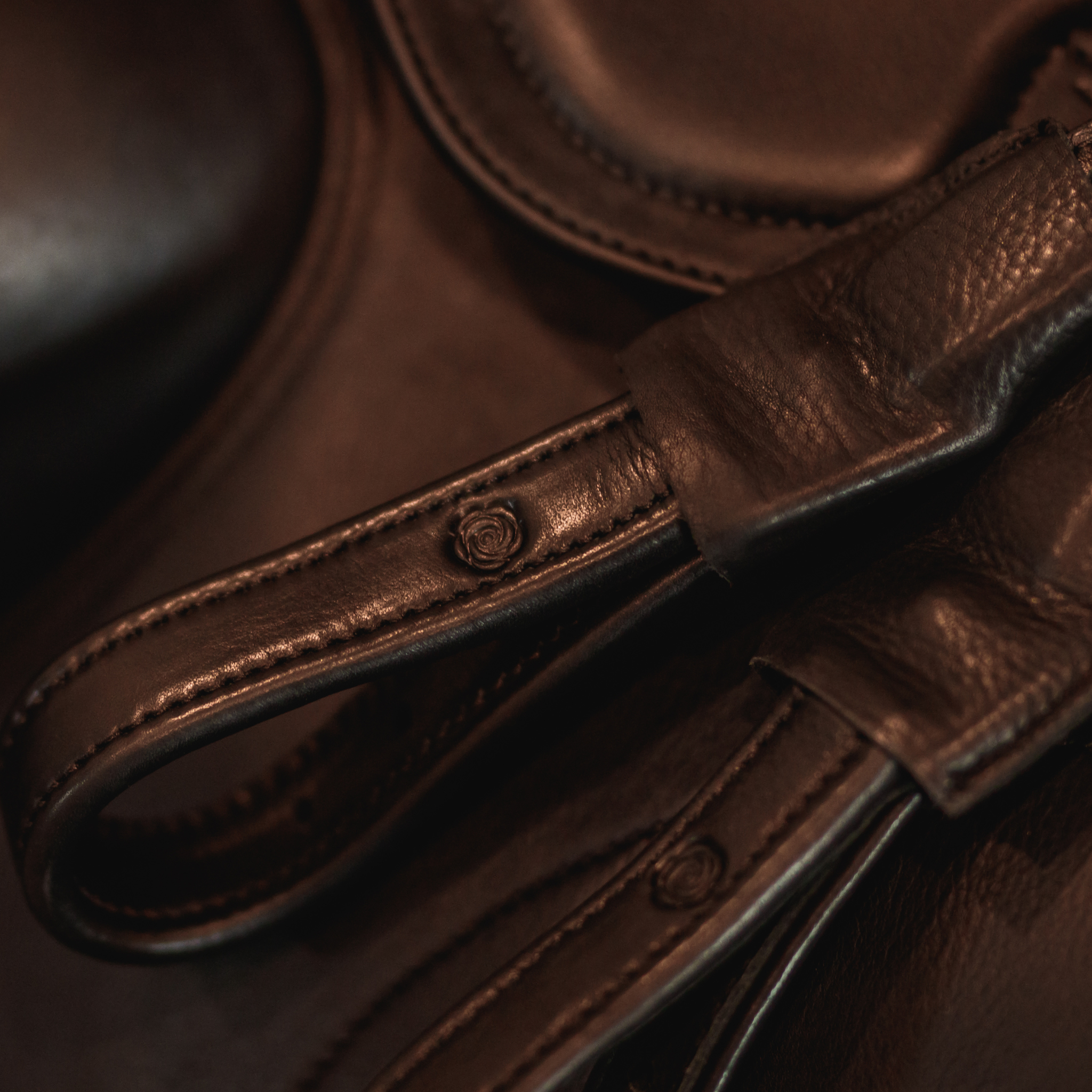 Black Brome Mono Leathers sitting on top of a black Amerigo dressage saddle.