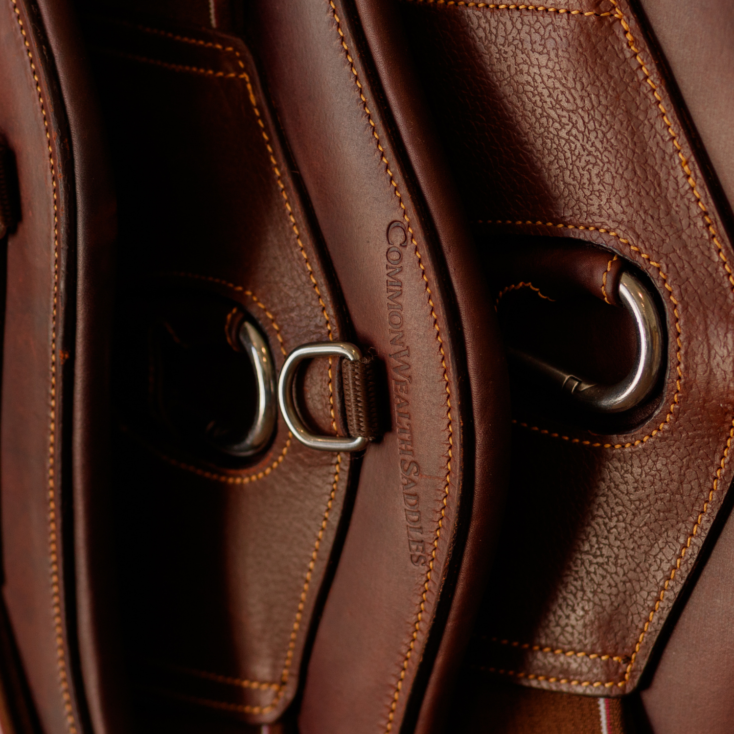 Close-up of multiple brown leather girths