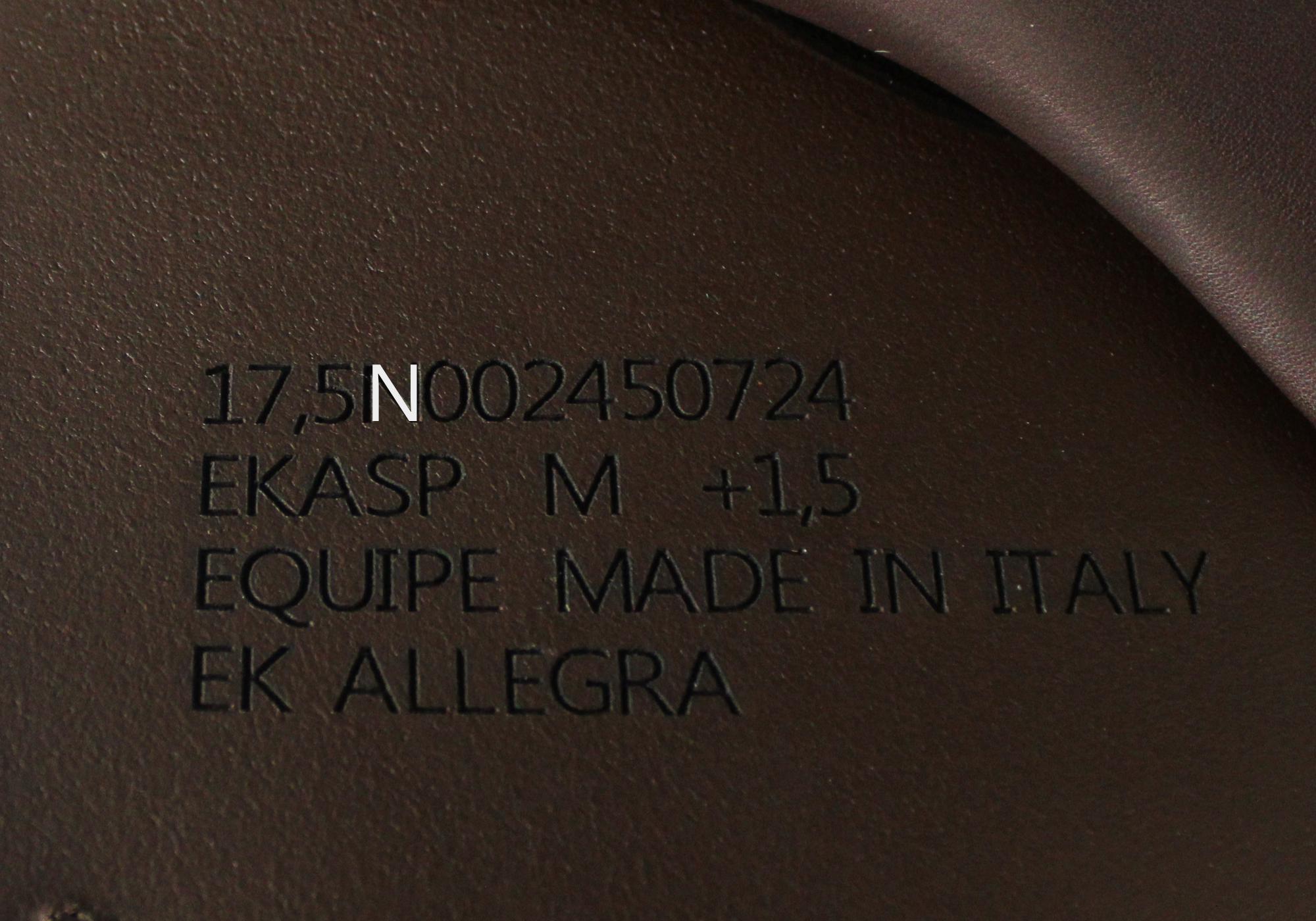 Close up of Equipe Stamp with "N" highlighted in white text. 