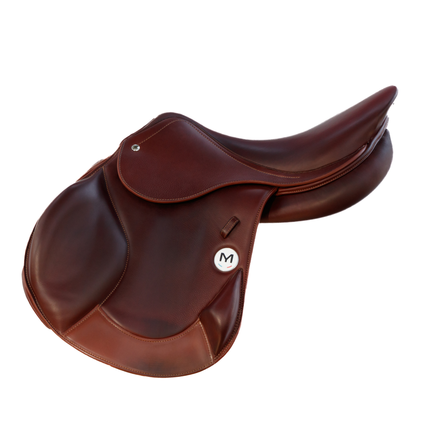 Side view of a brown calfskin leather Meyer Cross monoflap saddle with a circular white badge featuring a black letter 'M' and a small French tricolor detail.