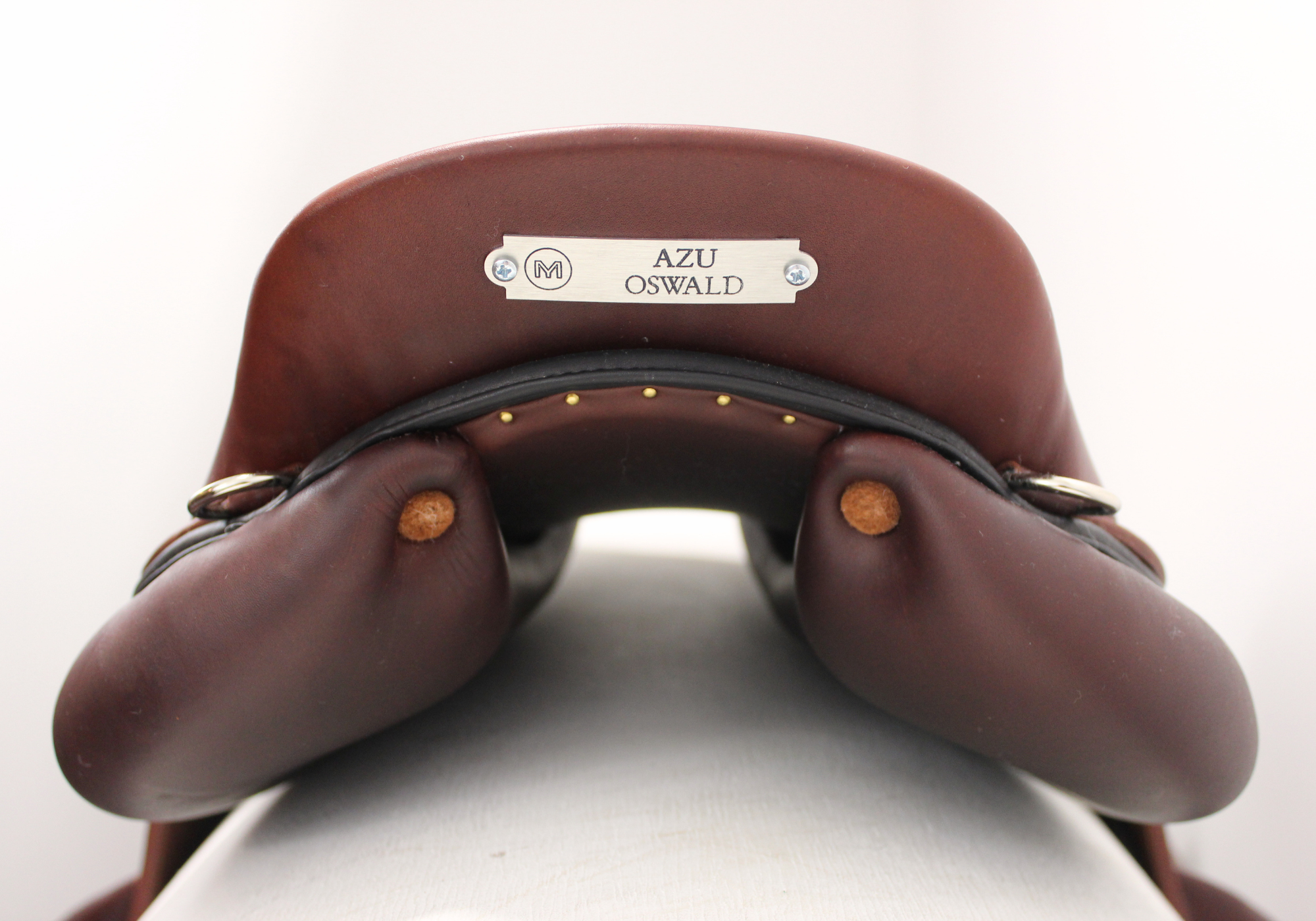 Rear view of a brown leather jump saddle with a silver Meyer namplate showing the width between the panels in the gullet channel.