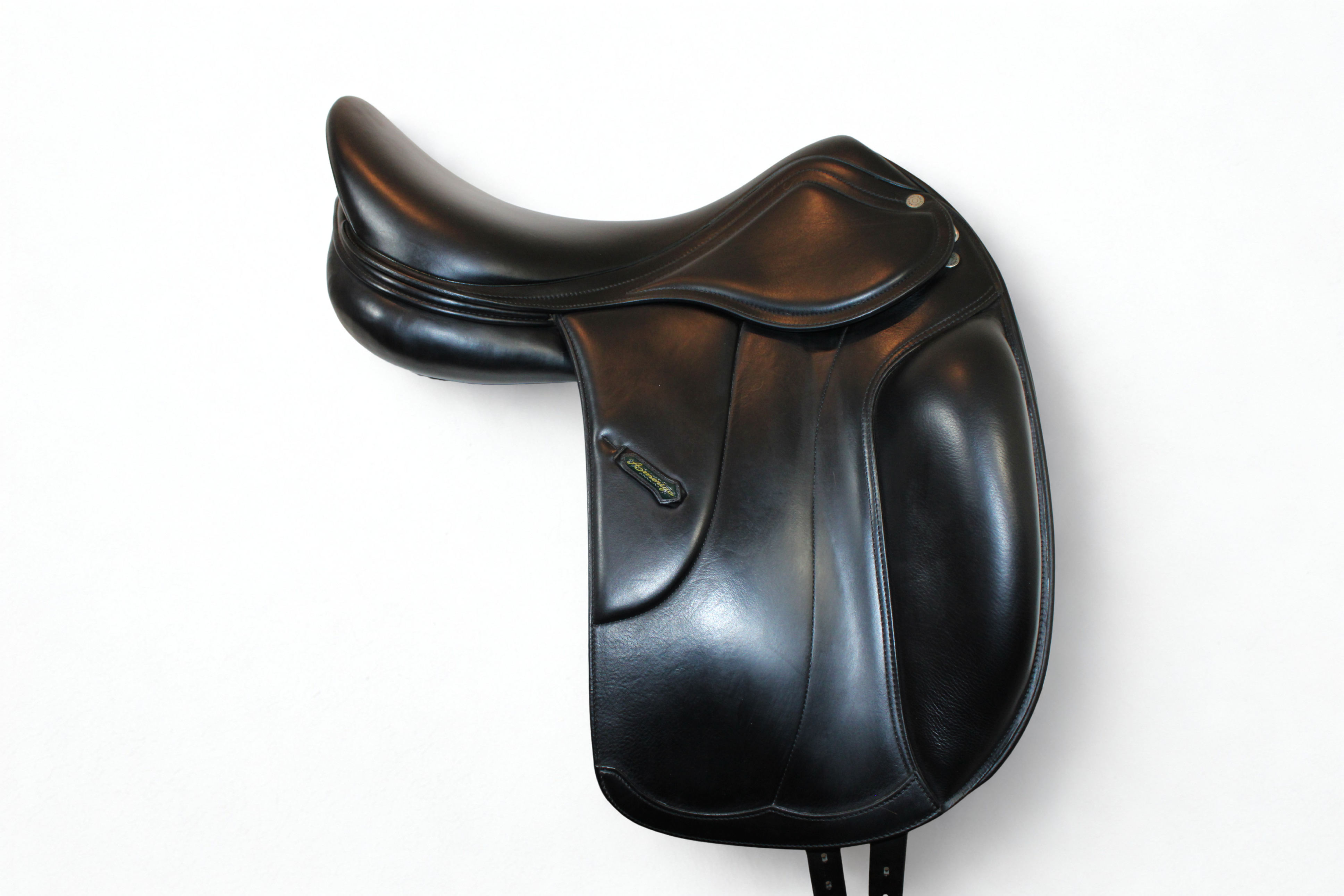 Right side profile view of an Amerigo Vega dressage saddle in black calf leather, with a green and yellow Amerigo logo loop.