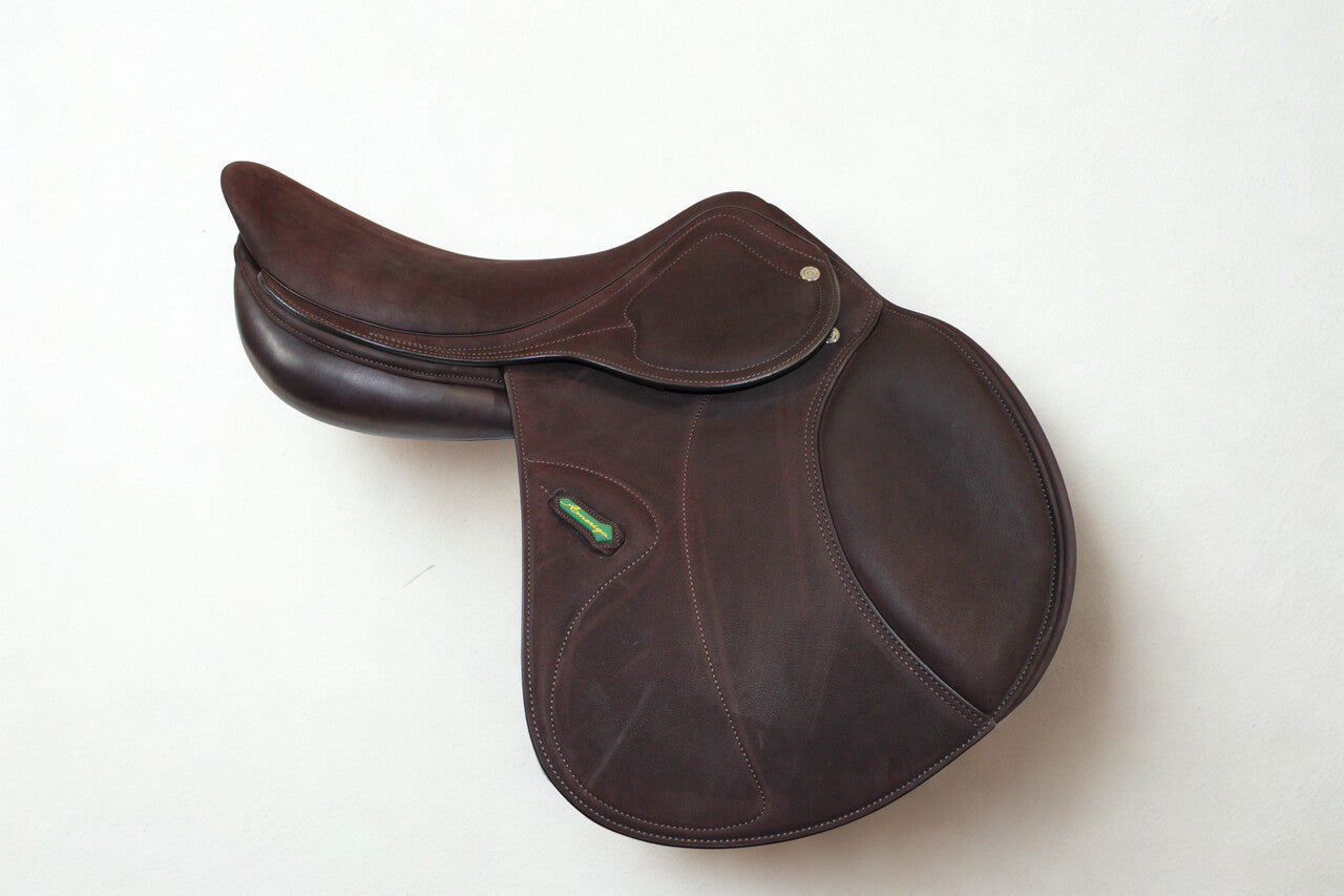 Right side profile view of an Amerigo DJ dual flap jump saddle in brown buffalo leather, with a green and yellow Amerigo logo loop.